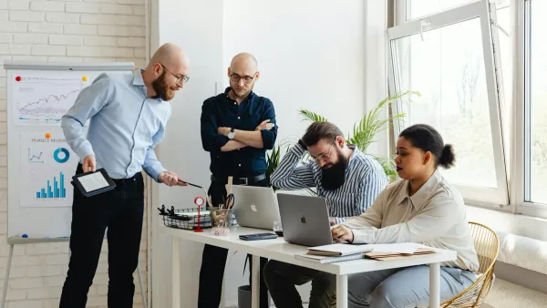 Office team discussing retirement benefits and 401k match changes in 2026