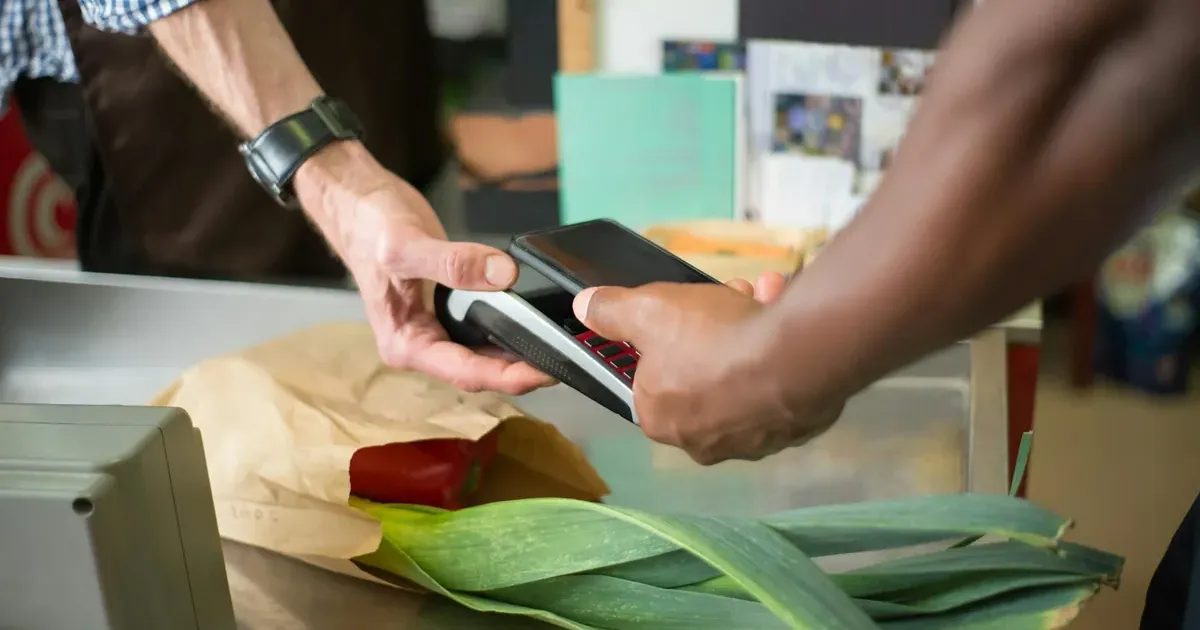 Person paying with smartphone at checkout — buy now pay later credit score impact