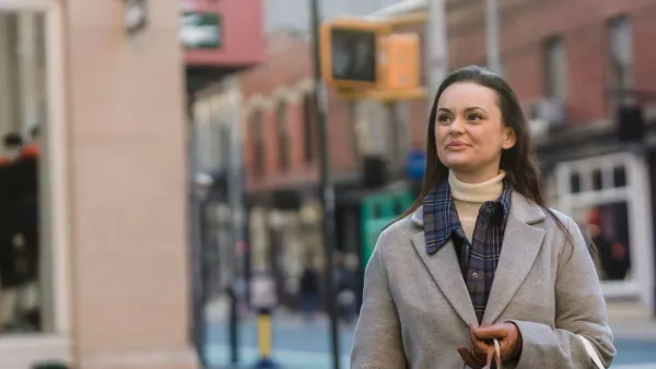 Shopper with gift bags on a city street planning a holiday gift budget for 2026