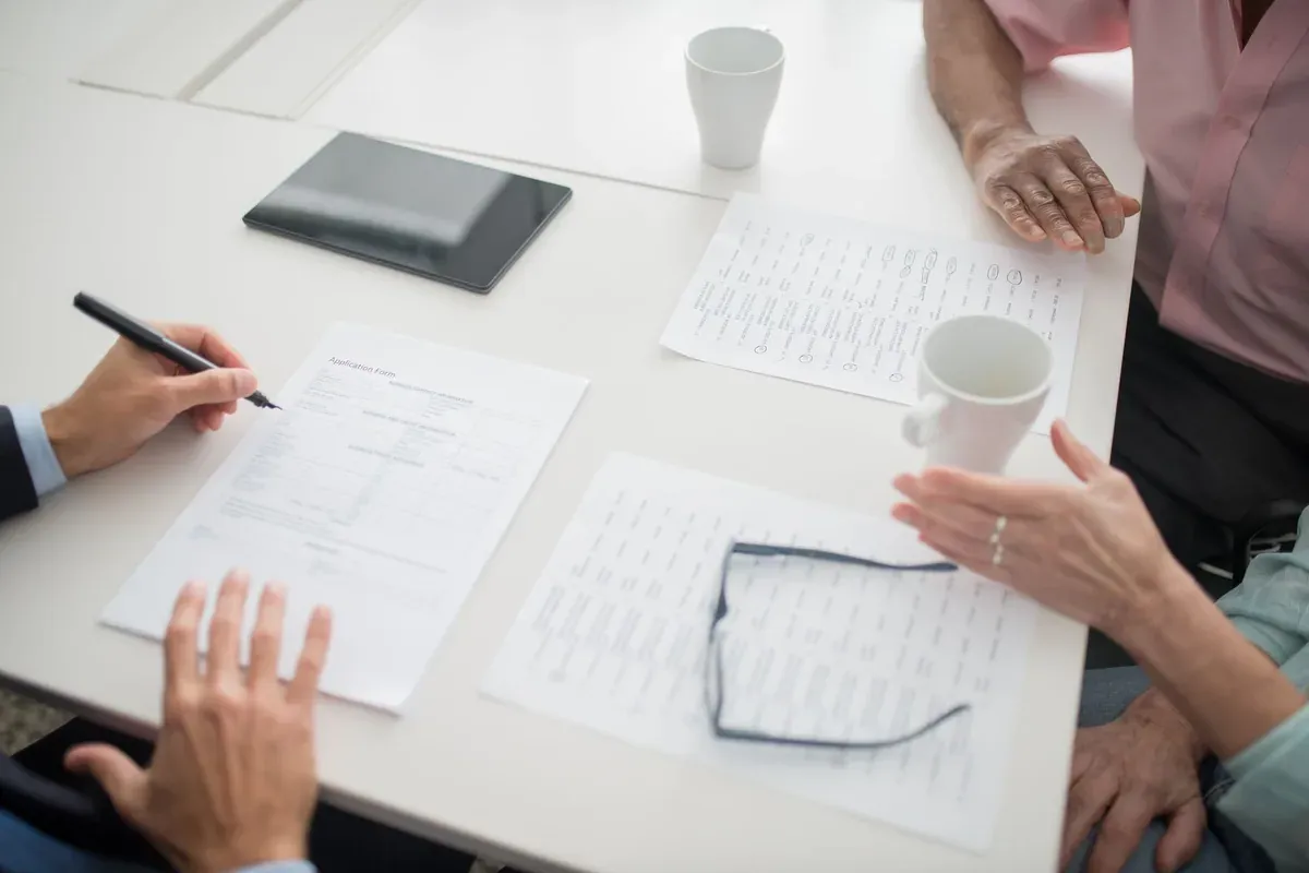Homeowner reviewing insurance paperwork at a kitchen table