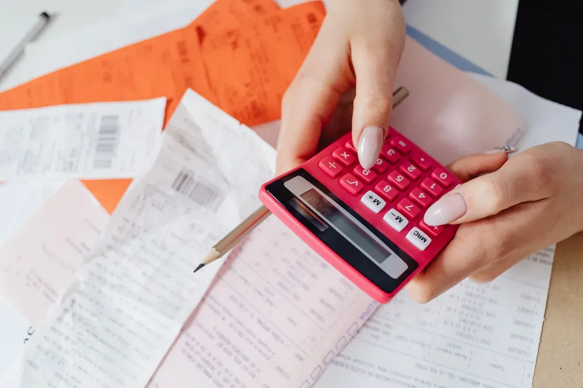 Calculator and financial documents on a desk representing healthcare expense tracking and planning