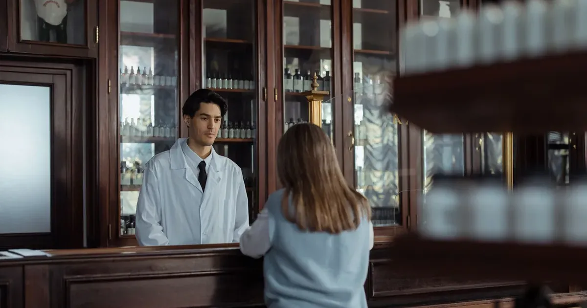 Person at pharmacy counter managing health savings account and FSA spending strategy
