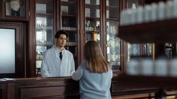 Person at pharmacy counter managing health savings account and FSA spending strategy