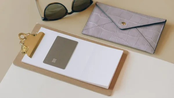 Flat lay of a no annual fee credit card next to a wallet, representing cashback rewards comparison