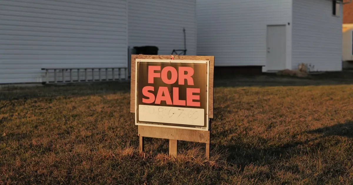 For sale sign in front of a suburban American house — rent vs buy 2026