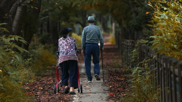 Senior couple walking together on an autumn path, representing retirees planning for the 2027 Social Security COLA
