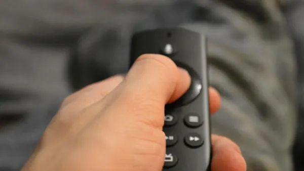 Person holding TV remote control — streaming subscription price hike audit 2026
