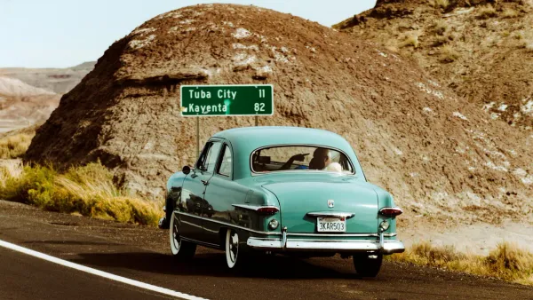 Vintage car on a summer road trip highway — summer travel budget 2026 planning
