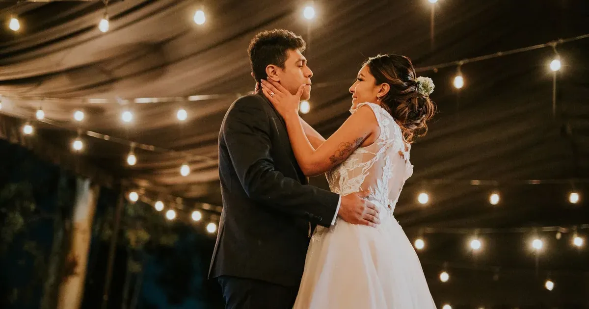 Wedding reception venue lit with string lights at dusk, representing wedding guest budget costs