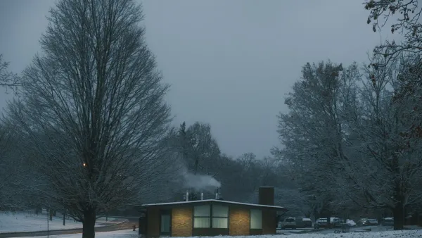 Snow-covered house at dusk representing a winter heating budget
